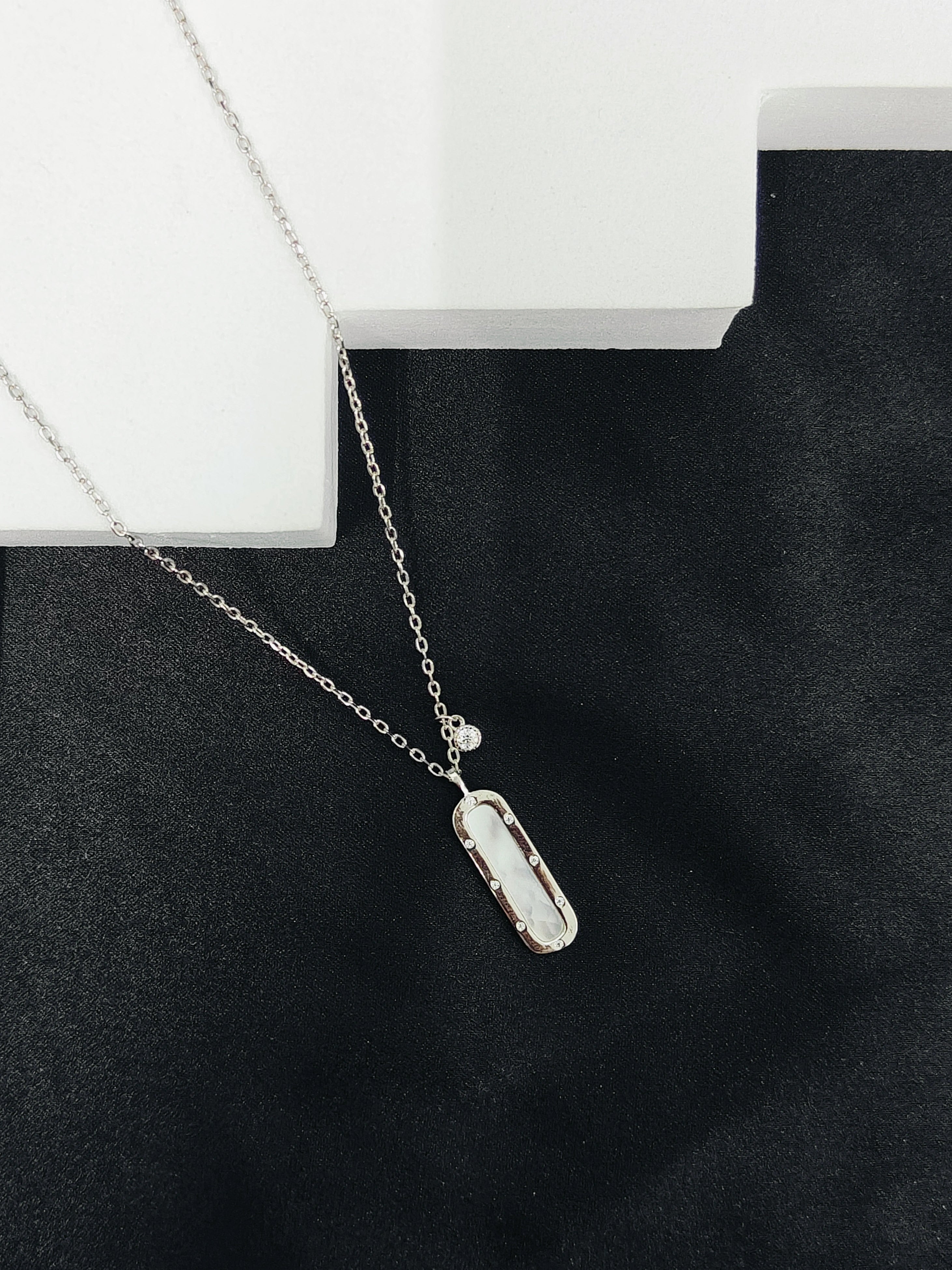 Necklace with a pendant on a black surface